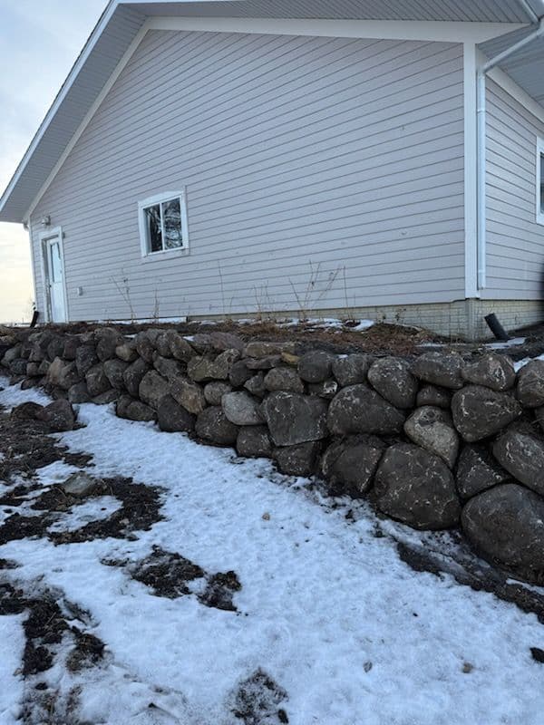 Boulder Retaining Wall Enhances Winter Charm image